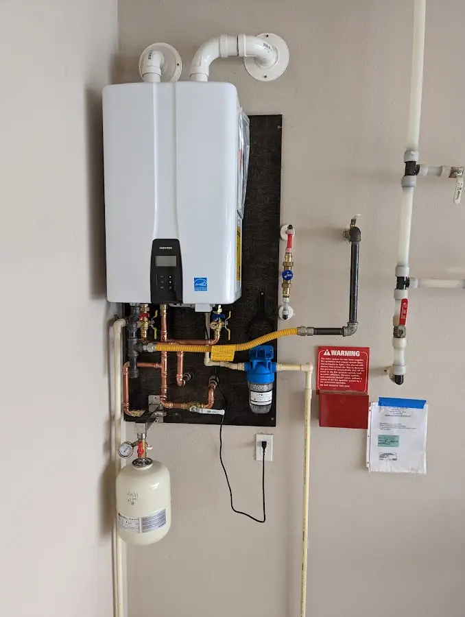 Professional plumber installing copper piping in a Clifton Forge home